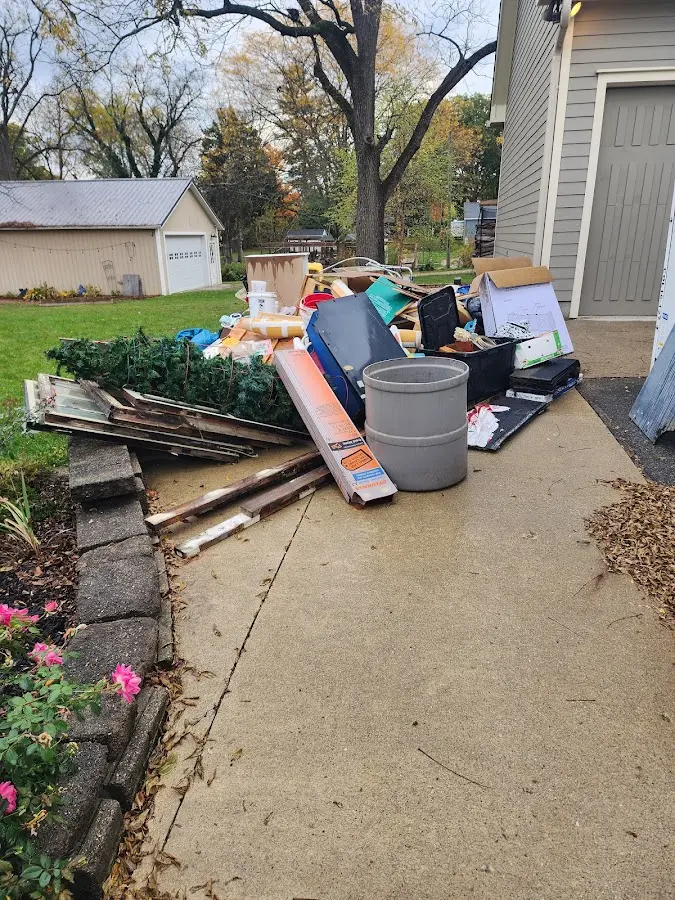 Dumpster being loaded with debris for Demolition Dumpster Rental in Madison